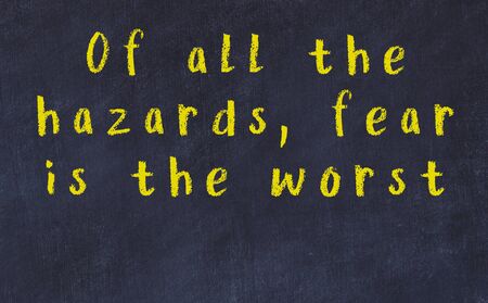 Chalk handwritten inscription of smart quotation on black chackboardの写真素材