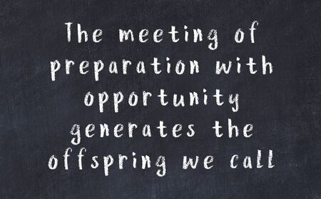 Smart saying handwritten with chalk on black desk