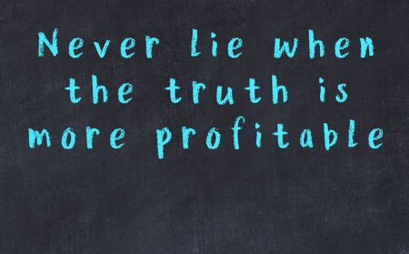 Chalk handwritten inscription of smart quotation on black chackboardの写真素材