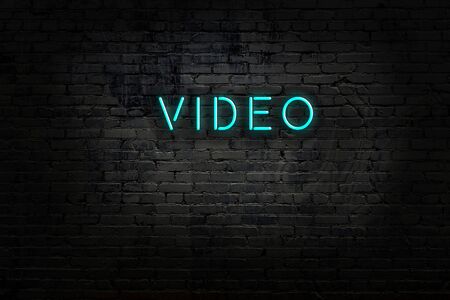 Neon sign with inscription video against brick wall. Night viewの写真素材