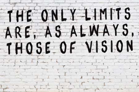 Black painted inscription of smart quotation on white brick wallの写真素材