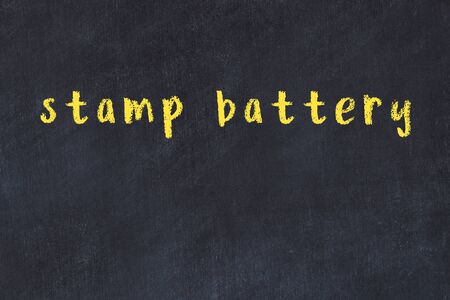 College chalkboard  with with handwritten inscription stamp battery on itの写真素材