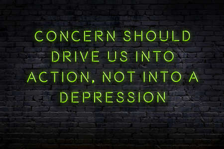 Night view on neon inscription of wise quotation on brick wallの写真素材