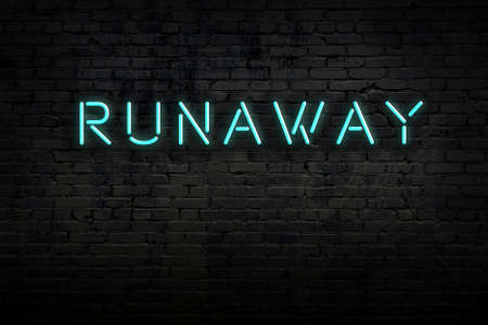 Neon sign on brick wall at night. Inscription runawayの写真素材
