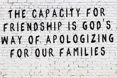 White brick wall with black painted inscription of sensible wise quote on itの写真素材