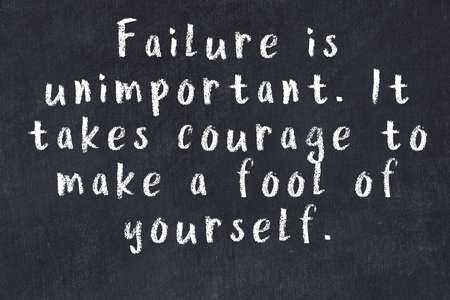 Chalk handwritten inscription of smart quotation on black chackboardの写真素材
