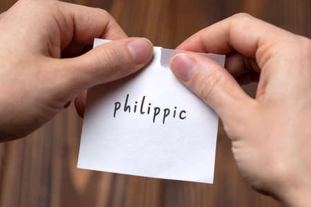 Canceling philippic. Hands tearing of a paper with handwritten inscription.の写真素材