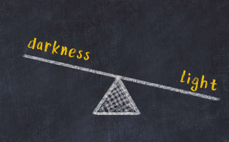 Balance between darkness and light. Chalkboard drawing on black chalkboardの写真素材