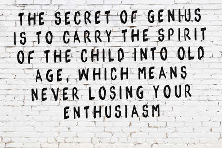 White brick wall and black painted inscription of wise quotationの写真素材