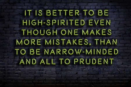 Night view on neon inscription of wise quotation on brick wallの写真素材