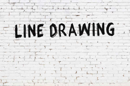 White brick wall with inscription line drawing handwritten with black paintの写真素材