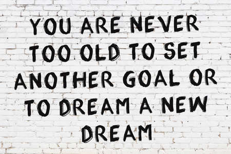 White brick wall and black painted inscription of wise quotation