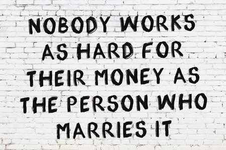 White brick wall and black painted inscription of wise quotationの写真素材