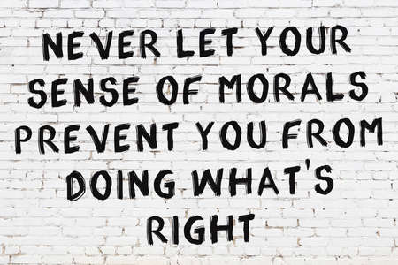 White brick wall and black painted inscription of wise quotationの写真素材