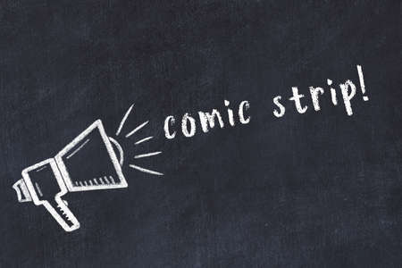 Chalk drawing of loudspeaker and handwritten inscription comic strip on black deskの写真素材
