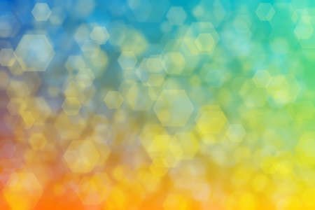 Abstract background gradient from blue to yellow colors and random bokeh pattern.