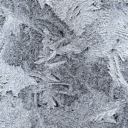 Ornate frosty pattern on the window glassの写真素材