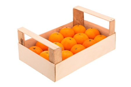 Ripe, juicy tangerines in a wooden box, stacked in a one row and photographed on a white backgroundの写真素材