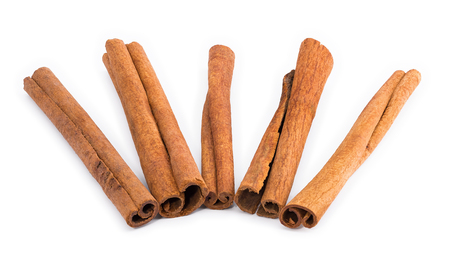 Five cinnamon sticks arranged like a fan on a white background.の写真素材
