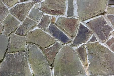 Wall clad in colorful flagstone with wide cement jointsの写真素材