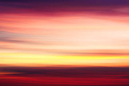 Blurry mystic sunset clouds shooted with camera motion as creative abstract backgroundの写真素材