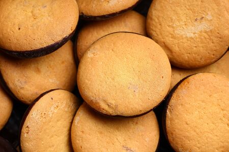 Chocolate glazed factory cookies close-up, background Conceptual and symbolic background.の写真素材