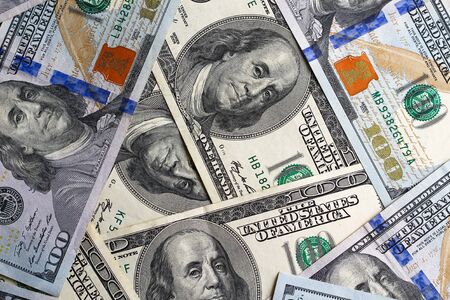 US dollars scattered randomly on the table, close up, backgroundの写真素材