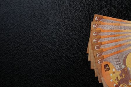 Euro lined with fan on black leather texture luxury backgroundの写真素材