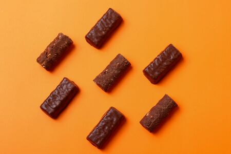 Chocolate candies on an orange background, dessertの写真素材