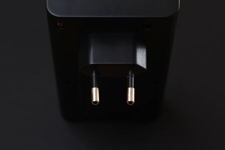 Charging for batteries on a black background in a low keyの写真素材