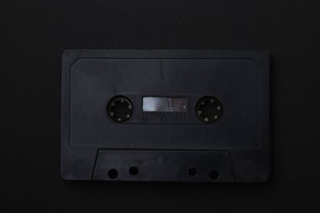 Black audio cassette close-up on a black backgroundの写真素材
