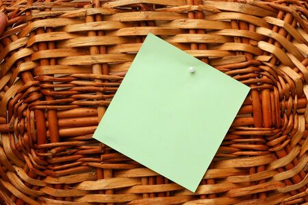 Blank sticker with place for inscription or text on the background of a wooden wicker basket.