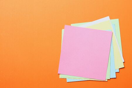 Multicolored stickers on an orange background with copyspace for inscription or text.の写真素材