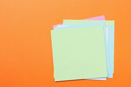 Multicolored stickers on an orange background with copyspace for inscription or text.の写真素材