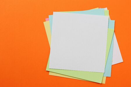 Multicolored stickers on an orange background with copyspace for inscription or text.の写真素材