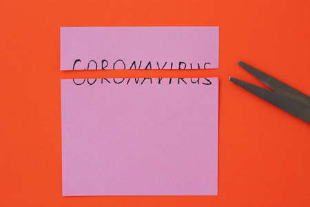 The inscription on the sticker: Coronavirus torn in half on an orange backgroundの写真素材