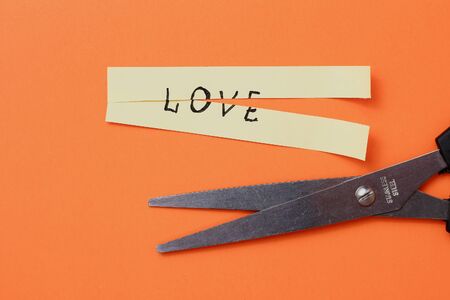 The inscription on the sticker: LOVE cut in half on an orange backgroundの写真素材