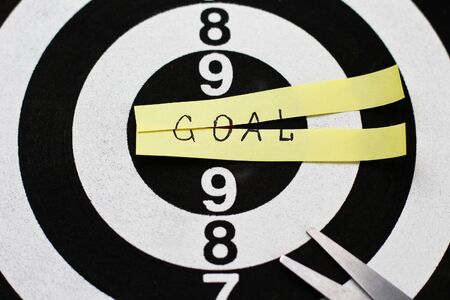 The inscription on the sticker: GOAL cut in half against the background of the target for shootingの写真素材