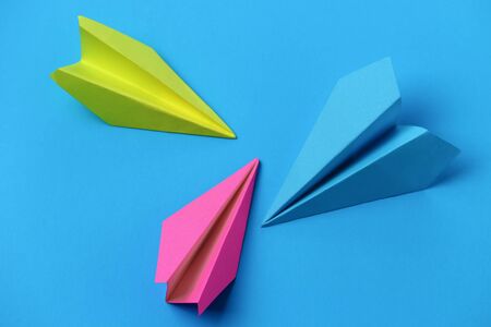 Paper airplanes, adventure symbol, on blue background