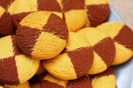 Two-color cookies in a plate close-up, backgroundの写真素材