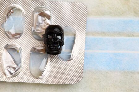 Medical mask and skull. Concept on the theme of the epidemic and pandemic, viral infections,...