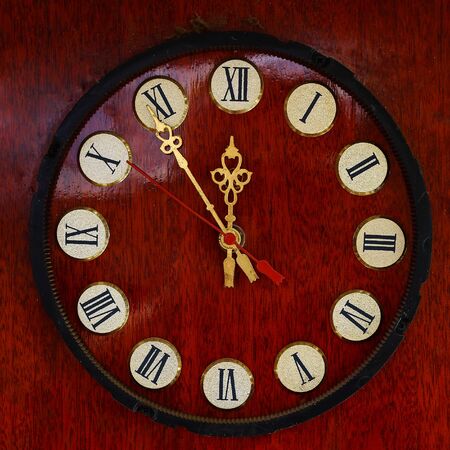 Antique wall clock of the 20s - 30s with a gold dial and a wooden base