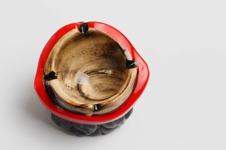 Empty ashtray for smoking on a light backgroundの写真素材