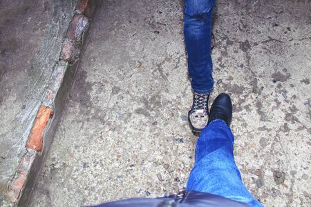 People in the context of the coronavirus pandemic began to greet each other by touching shoes,...