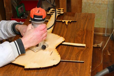 The process of wood milling by hand milling. An unusual hobby of carving wood. Toned backgroundの写真素材