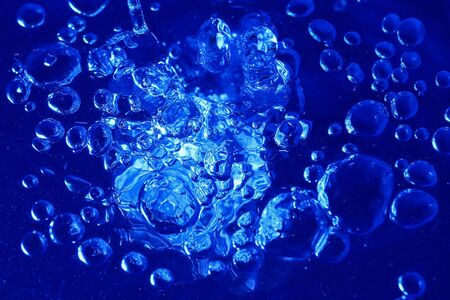 Abstract toned blue background with bubbles of water, wallpaper blank, substrate for text or lettering, pattern for designの写真素材