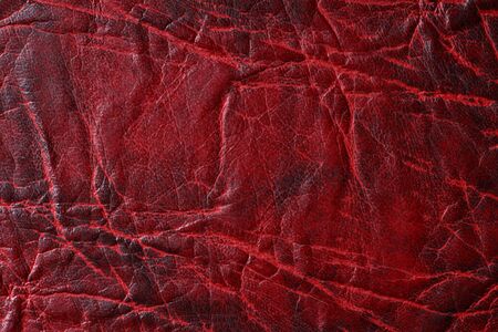 Dark texture of brown crumpled genuine leather, background, wallpaper, substrate, blank for designの写真素材