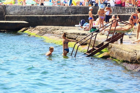 Odessa, Ukraine July 20, 2019, People on the city beach sunbathe in the midst of the tourist season . Editorial Use Onlyのeditorial素材