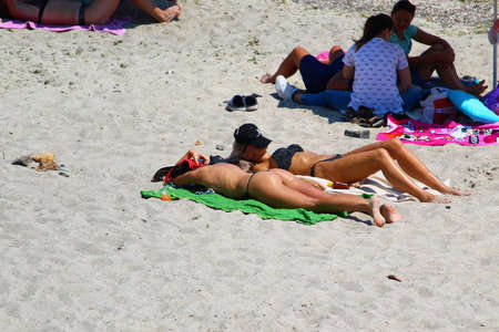 Odessa, Ukraine July 21, 2019, People on the city beach sunbathe in the midst of the tourist season . Editorial Use Onlyのeditorial素材