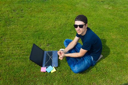 A man tied to a laptop with a metal chain, toned. The concept of dependence on gadgets, social...